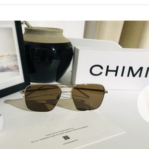 Chimi sunglasses. 56mm. Golden frame, brown lens.